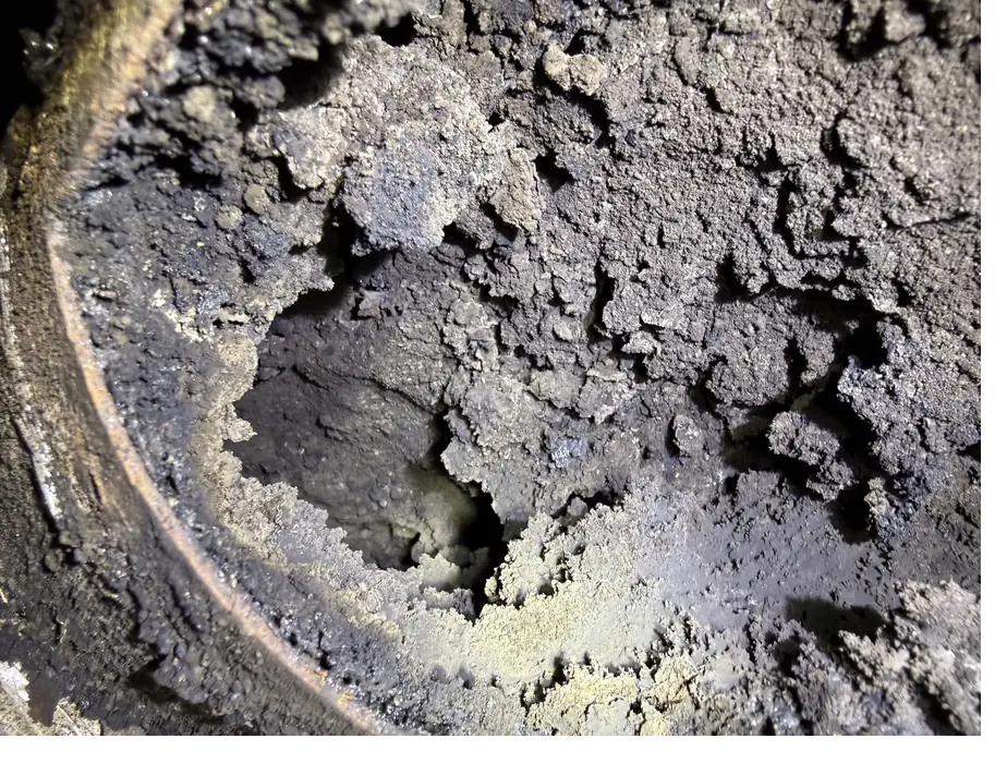 Heavy creosote and ash deposits inside a biomass flue