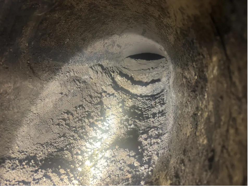 CCTV view up a sooted flue showing the throat and liner