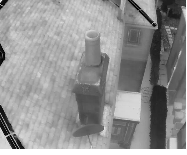 Thermal drone image of a chimney stack and roof